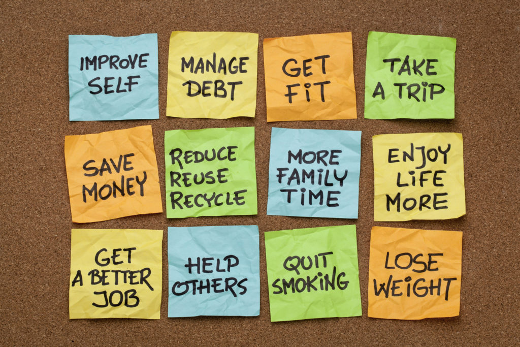 popular new year resolutions - colorful sticky notes on a cork board