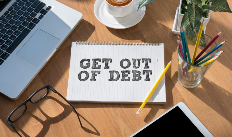 Get Out of Debt concept open book on table and coffee Business