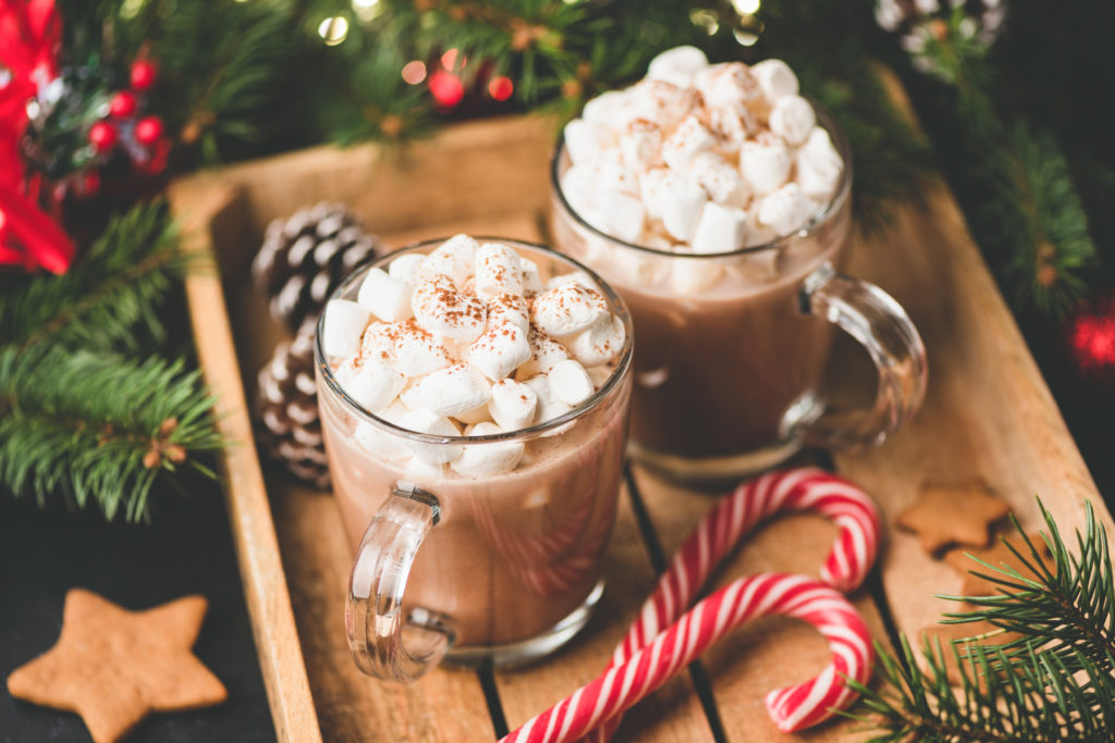 Hot chocolate with marshmallows, warm cozy Christmas drink in a wooden tray