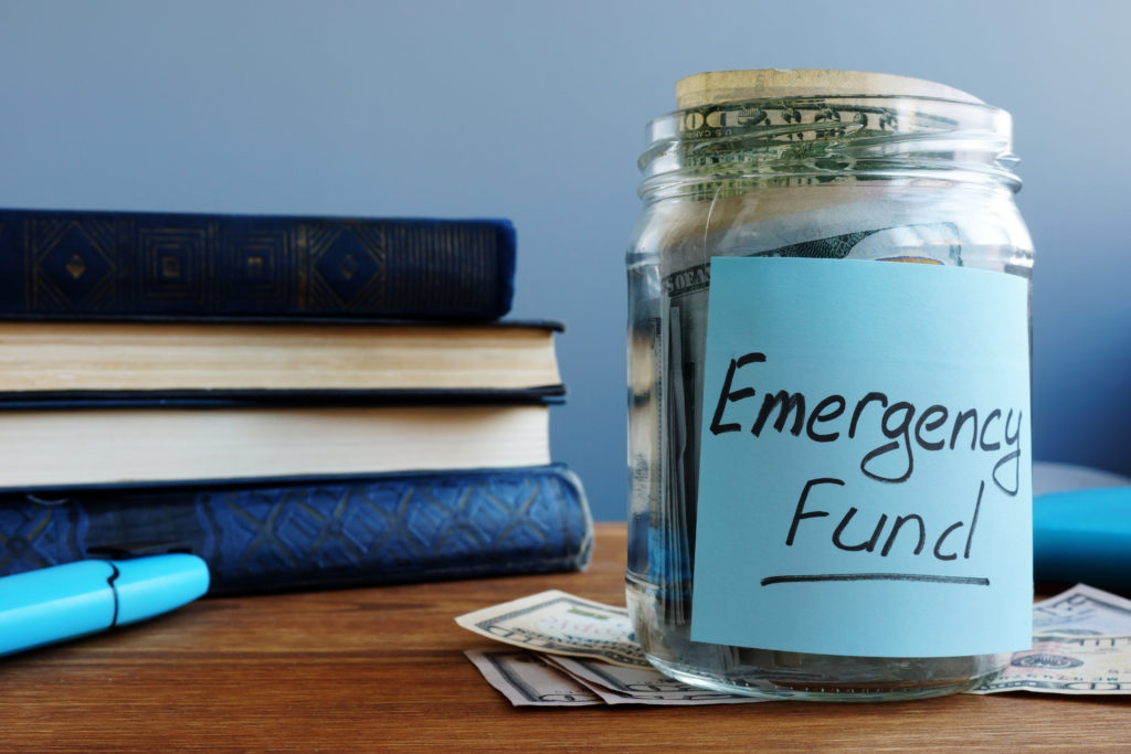 Emergency fund written on a jar with money.
